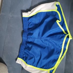 Blue athletic shorts with white & yellow accents. Size medium. Danskin Now.